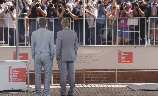 Brad Pitt, left, and George Clooney pose for photographers upon arrival for the press conference of the film 'Wolfs' during the 81st edition of the Venice Film Festival in Venice, Italy, on Sunday, Sept. 1, 2024. (Photo by Vianney Le Caer/Invision/AP)