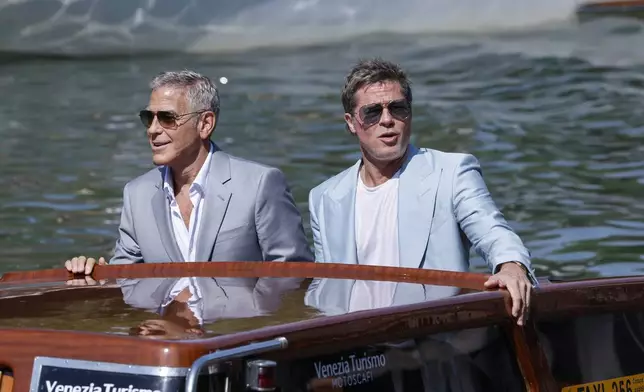 George Clooney, left, and Brad Pitt upon arrival for the press conference of the film 'Wolfs' during the 81st edition of the Venice Film Festival in Venice, Italy, on Sunday, Sept. 1, 2024. (Photo by Joel C Ryan/Invision/AP)