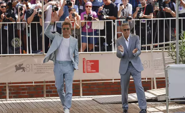 Brad Pitt, left, and George Clooney pose for photographers upon arrival for the press conference of the film 'Wolfs' during the 81st edition of the Venice Film Festival in Venice, Italy, on Sunday, Sept. 1, 2024. (Photo by Vianney Le Caer/Invision/AP)