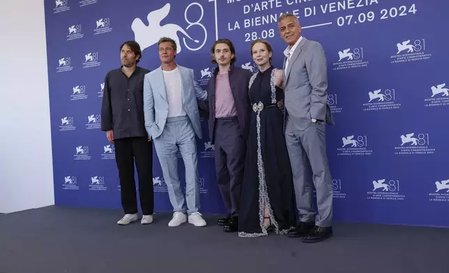 Director Jon Watts, from left, Brad Pitt, Austin Abrams, Amy Ryan and George Clooney pose for photographers at the photo call for the film 'Wolfs' during the 81st edition of the Venice Film Festival in Venice, Italy, on Sunday, Sept. 1, 2024. (Photo by Joel C Ryan/Invision/AP)