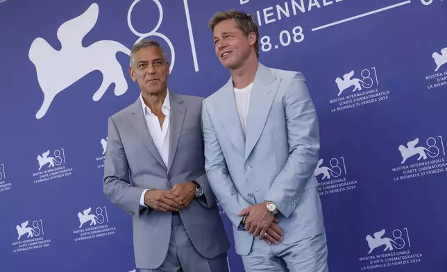 George Clooney, left, and Brad Pitt pose for photographers at the photo call for the film 'Wolfs' during the 81st edition of the Venice Film Festival in Venice, Italy, on Sunday, Sept. 1, 2024. (Photo by Joel C Ryan/Invision/AP)