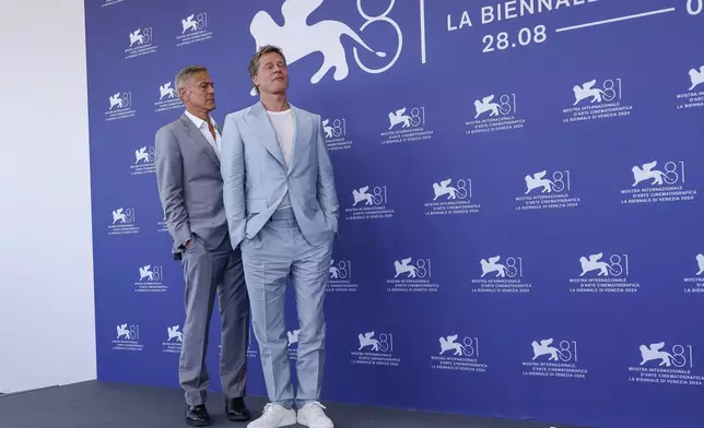 George Clooney, left, and Brad Pitt pose for photographers at the photo call for the film 'Wolfs' during the 81st edition of the Venice Film Festival in Venice, Italy, on Sunday, Sept. 1, 2024. (Photo by Joel C Ryan/Invision/AP)