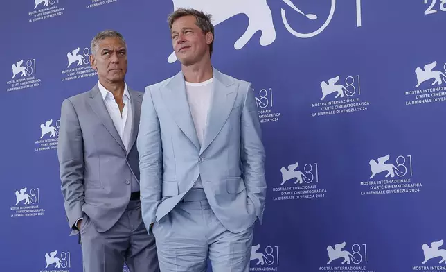 George Clooney, left, and Brad Pitt pose for photographers at the photo call for the film 'Wolfs' during the 81st edition of the Venice Film Festival in Venice, Italy, on Sunday, Sept. 1, 2024. (Photo by Joel C Ryan/Invision/AP)