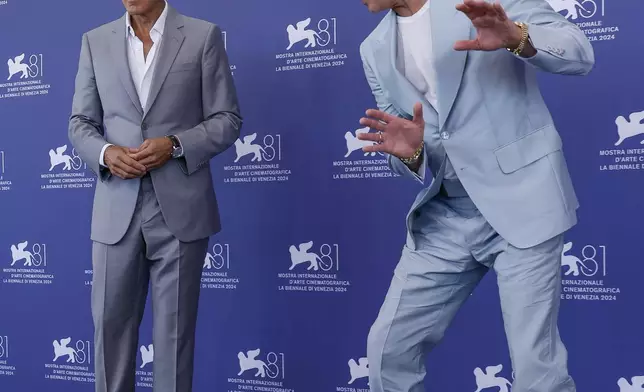 George Clooney, left, and Brad Pitt pose for photographers at the photo call for the film 'Wolfs' during the 81st edition of the Venice Film Festival in Venice, Italy, on Sunday, Sept. 1, 2024. (Photo by Joel C Ryan/Invision/AP)