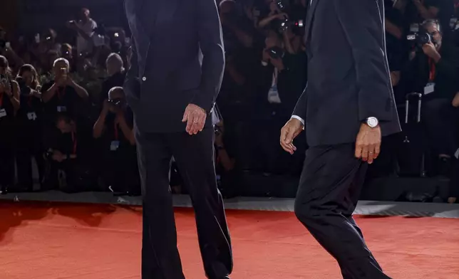 Brad Pitt, left, and George Clooney pose for photographers upon arrival for the premiere of the film 'Wolfs' during the 81st edition of the Venice Film Festival in Venice, Italy, on Sunday, Sept. 1, 2024. (Photo by Joel C Ryan/Invision/AP)