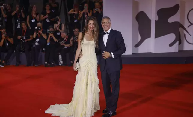 Amal Clooney, left, and George Clooney pose for photographers upon arrival for the premiere of the film 'Wolfs' during the 81st edition of the Venice Film Festival in Venice, Italy, on Sunday, Sept. 1, 2024. (Photo by Vianney Le Caer/Invision/AP)