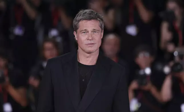 Brad Pitt poses for photographers upon arrival for the premiere of the film 'Wolfs' during the 81st edition of the Venice Film Festival in Venice, Italy, on Sunday, Sept. 1, 2024. (Photo by Vianney Le Caer/Invision/AP)