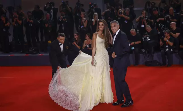 George Clooney, right, and Amal Clooney pose for photographers upon arrival for the premiere of the film 'Wolfs' during the 81st edition of the Venice Film Festival in Venice, Italy, on Sunday, Sept. 1, 2024. (Photo by Vianney Le Caer/Invision/AP)