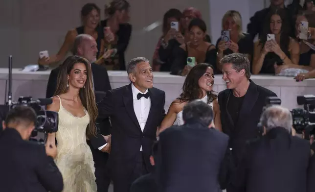 Amal Clooney, from left, George Clooney, Ines de Ramon, and Brad Pitt pose for photographers upon arrival for the premiere of the film 'Wolfs' during the 81st edition of the Venice Film Festival in Venice, Italy, on Sunday, Sept. 1, 2024. (Photo by Vianney Le Caer/Invision/AP)