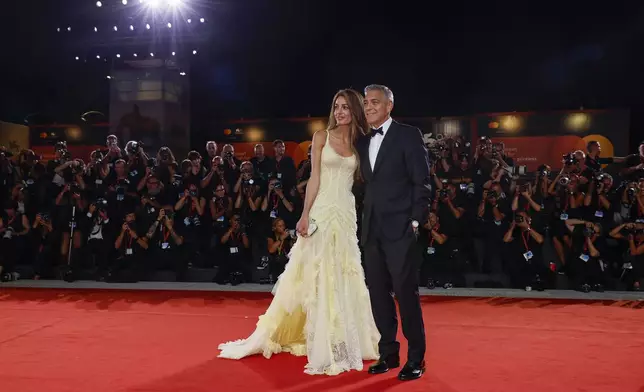 Amal Clooney, left, and George Clooney pose for photographers upon arrival for the premiere of the film 'Wolfs' during the 81st edition of the Venice Film Festival in Venice, Italy, on Sunday, Sept. 1, 2024. (Photo by Joel C Ryan/Invision/AP)