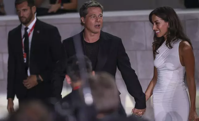 Brad Pitt, left, and Ines de Ramon upon arrival for the premiere of the film 'Wolfs' during the 81st edition of the Venice Film Festival in Venice, Italy, on Sunday, Sept. 1, 2024. (Photo by Vianney Le Caer/Invision/AP)