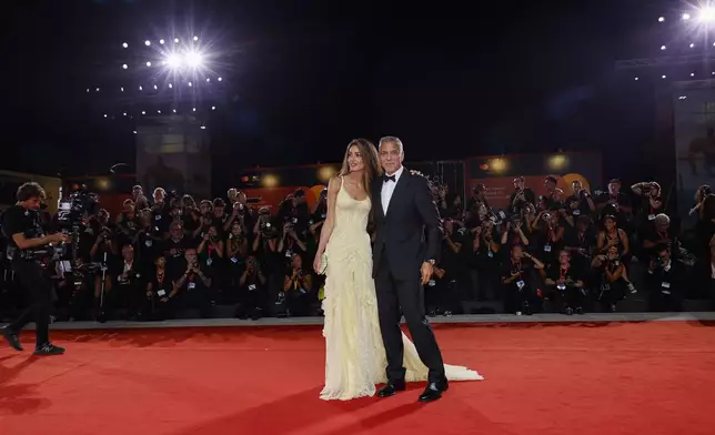 Amal Clooney, left, and George Clooney pose for photographers upon arrival for the premiere of the film 'Wolfs' during the 81st edition of the Venice Film Festival in Venice, Italy, on Sunday, Sept. 1, 2024. (Photo by Joel C Ryan/Invision/AP)