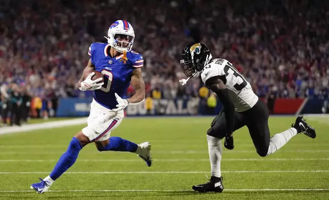 Buffalo Bills wide receiver Keon Coleman, left, scores a touchdown past Jacksonville Jaguars cornerback Montaric Brown during the first half of an NFL football game Monday, Sept. 23, 2024, in Orchard Park, NY. (AP Photo/Steven Senne)