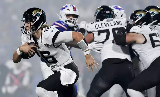 Jacksonville Jaguars quarterback Trevor Lawrence (16) runs out of the pocket during the first half of an NFL football game against the Buffalo Bills, Monday, Sept. 23, 2024, in Orchard Park, NY. (AP Photo/Adrian Kraus)