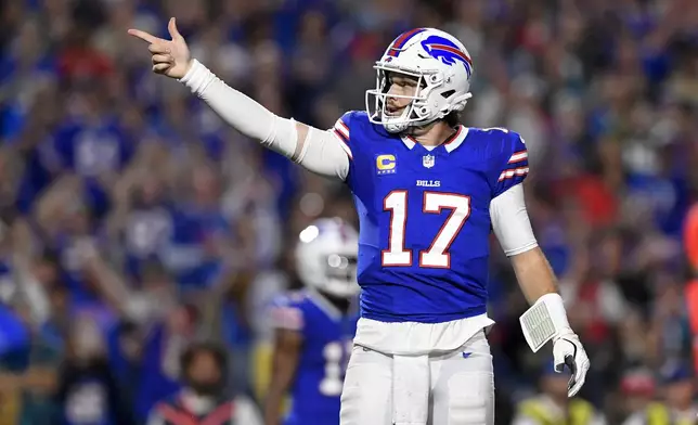 Buffalo Bills quarterback Josh Allen (17) signals for a first down during the first half of an NFL football game against the Jacksonville Jaguars, Monday, Sept. 23, 2024, in Orchard Park, NY. (AP Photo/Adrian Kraus)