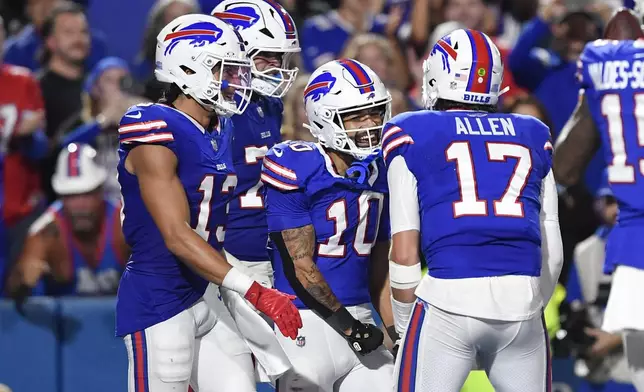 Buffalo Bills wide receiver Khalil Shakir (10) celebrates his touchdown catch with teammates during the first half of an NFL football game against the Jacksonville Jaguars, Monday, Sept. 23, 2024, in Orchard Park, NY. (AP Photo/Adrian Kraus)