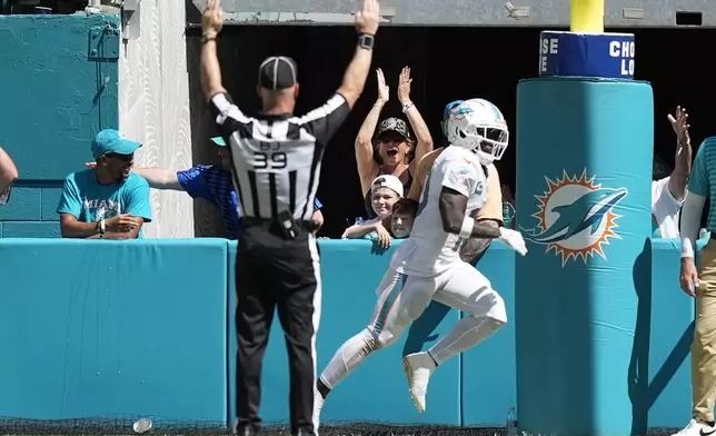 Miami Dolphins wide receiver Tyreek Hill (10) scores a touchdown during the second half of an NFL football game against the Jacksonville Jaguars, Sunday, Sept. 8, 2024, in Miami Gardens, Fla. (AP Photo/Rebecca Blackwell)