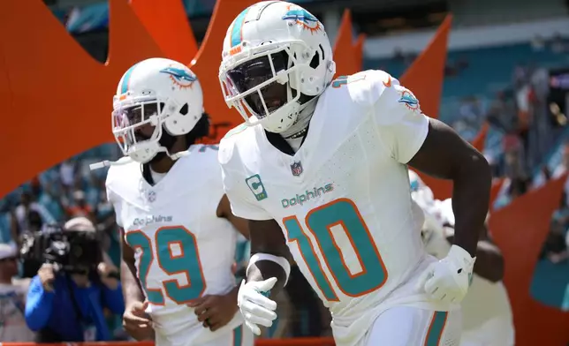 Miami Dolphins wide receiver Tyreek Hill (10) enters the field before an NFL football game against the Jacksonville Jaguars, Sunday, Sept. 8, 2024, in Miami Gardens, Fla. (AP Photo/Rebecca Blackwell)