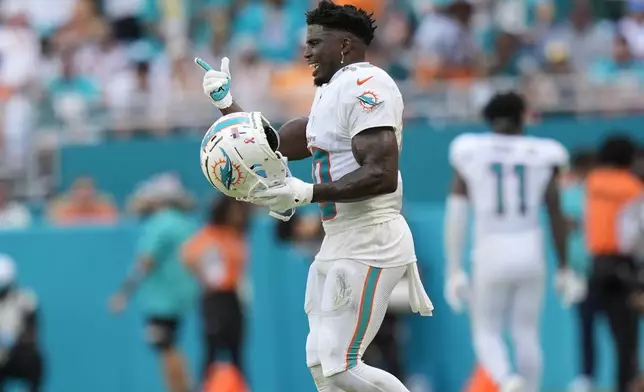 Miami Dolphins wide receiver Tyreek Hill (10) gestures during the second half of an NFL football game against the Jacksonville Jaguars, Sunday, Sept. 8, 2024, in Miami Gardens, Fla. The Dolphins defeated the Jaguars 20-17. (AP Photo/Rebecca Blackwell)