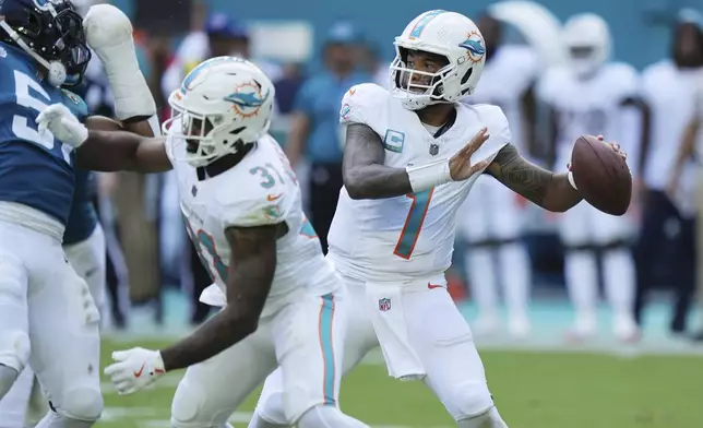 Miami Dolphins quarterback Tua Tagovailoa (1) aims a pass during the first half of an NFL football game against the Jacksonville Jaguars, Sunday, Sept. 8, 2024, in Miami Gardens, Fla. (AP Photo/Wilfredo Lee)