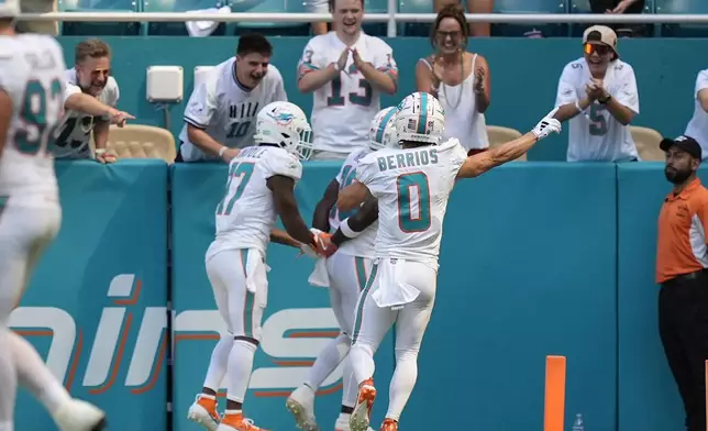 Miami Dolphins wide receiver Jaylen Waddle (17), Miami Dolphins wide receiver Braxton Berrios (0) celebrate a touchdown by Miami Dolphins wide receiver Tyreek Hill (10) during the second half of an NFL football game, Sunday, Sept. 8, 2024, in Miami Gardens, Fla. (AP Photo/Rebecca Blackwell)