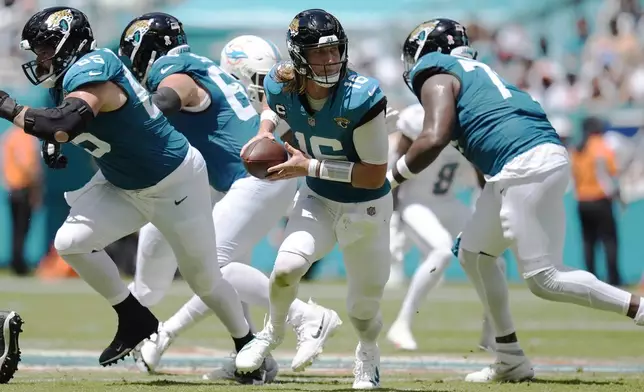 Jacksonville Jaguars quarterback Trevor Lawrence (16) looks to pass the ball during the first half of an NFL football game against the Miami Dolphins, Sunday, Sept. 8, 2024, in Miami Gardens, Fla. (AP Photo/Rebecca Blackwell)