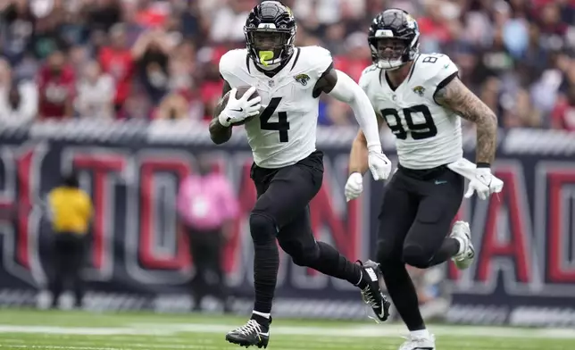 Jacksonville Jaguars running back Tank Bigsby (4) carries the ball up field during the second half of an NFL football game against the Houston Texans, Sunday, Sept. 29, 2024, in Houston. (AP Photo/Eric Christian Smith)