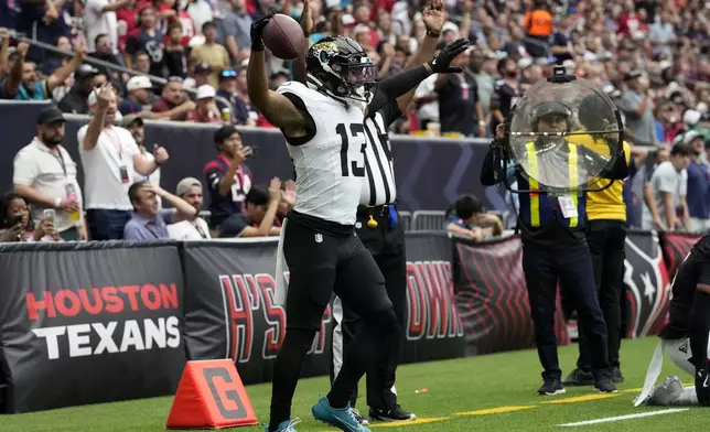 Jacksonville Jaguars wide receiver Christian Kirk celebrates after catching an 8-yard touchdown pass during the second half of an NFL football game against the Houston Texans, Sunday, Sept. 29, 2024, in Houston. (AP Photo/Eric Gay)