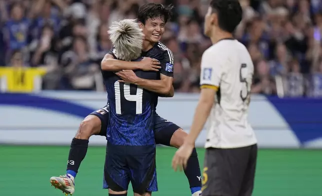 Japan's Junya Ito, 14, celebrates his goal with his teammate Takefusa Kubo during a World Cup and AFC Asian Qualifier between Japan and China at Saitama Stadium 2002 in Saitama, north of Tokyo, Thursday, Sept. 5, 2024.(AP Photo/Shuji Kajiyama)