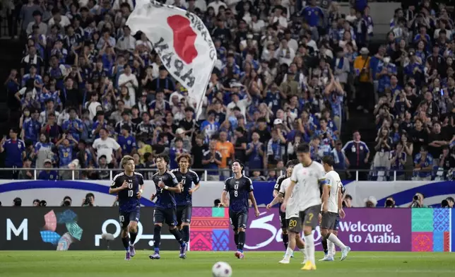 Japan's Kaoru Mitoma, left, celebrates his teams second goal during a World Cup and AFC Asian Qualifier between Japan and China at Saitama Stadium 2002 in Saitama, north of Tokyo, Thursday, Sept. 5, 2024.(AP Photo/Shuji Kajiyama)