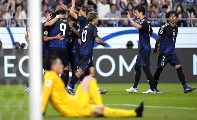 Japan's players celebrate Japan's fourth goal during a World Cup and AFC Asian Qualifier between Japan and China at Saitama Stadium 2002 in Saitama, north of Tokyo, Thursday, Sept. 5, 2024.(AP Photo/Shuji Kajiyama)