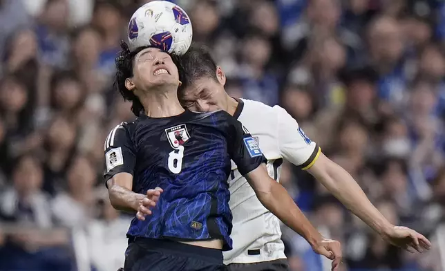 Japan's Takumi Minamino, left, and China's Li Yuanyi, right, fight for the ball during a World Cup and AFC Asian Qualifier between Japan and China at Saitama Stadium 2002 in Saitama, north of Tokyo, Thursday, Sept. 5, 2024.(AP Photo/Shuji Kajiyama)