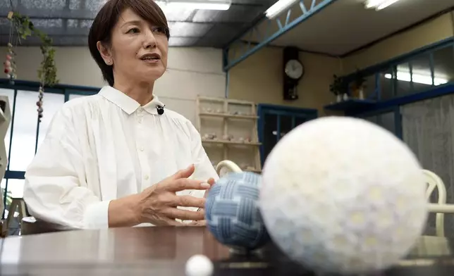 Eiko Araki, a master of the traditional Japanese craft of Sanuki Kagari Temari, talks to The Associated Press at her studio in Kawaramachi, Kagawa prefecture, Japan, on Sept. 5, 2024. (AP Photo/Ayaka McGill)