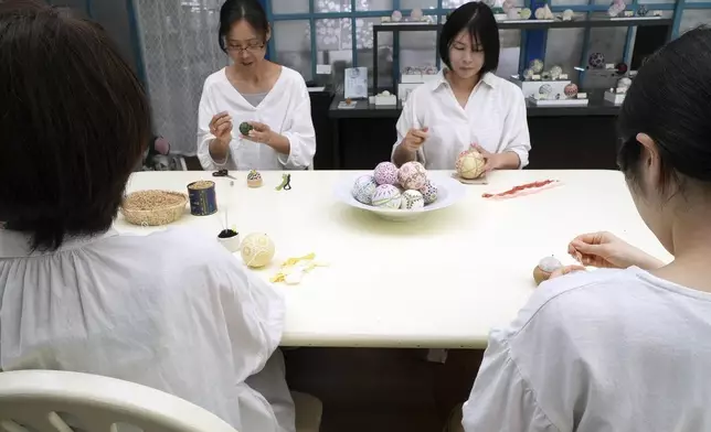 Staff work on the temari at Sanuki Kagari Temari in Kawaramachi, Kagawa prefecture, Japan, on Sept. 5, 2024. (AP Photo/Ayaka McGill)