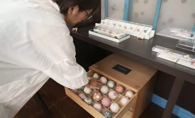 Eiko Araki, a master of the traditional Japanese craft of Sanuki Kagari Temari, shows several temari balls at her studio in Kawaramachi, Kagawa prefecture, Japan, on Sept. 5, 2024. (AP Photo/Ayaka McGill)