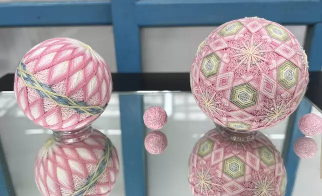 Two completed Sanuki Kagari Temari balls are on display in Eiko Araki's studio in Kawaramachi, Kagawa prefecture, Japan, on Sept. 5, 2024. (AP Photo/Yuri Kageyama)