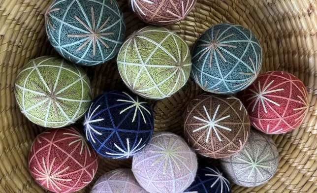 Several completed Sanuki Kagari Temari balls are on display in Eiko Araki's studio in Kawaramachi, Kagawa prefecture, Japan, on Sept. 5, 2024. (AP Photo/Yuri Kageyama)