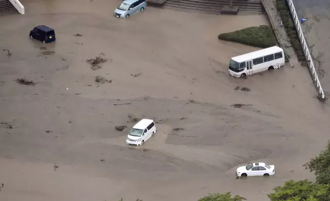 In this aerial photo, the car park of a municipal office is seen under water, after heavy rain in Wajima, Ishikawa prefecture, Saturday, Sept. 21, 2024. (Kyodo News via AP)