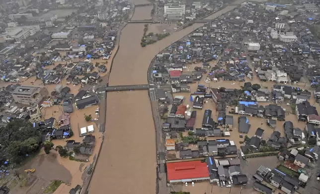 This aerial photo shows the flooded Kawarada river and submerged area after heavy rain in Wajima, Ishikawa prefecture, Saturday, Sept. 21, 2024. (Kyodo News via AP)