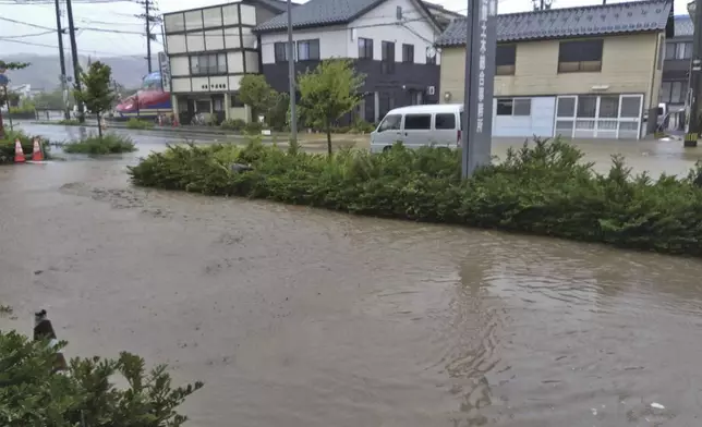 A road is flooded after heavy rain in Wajima, Ishikawa prefecture, Saturday, Sept. 21, 2024. (Kyodo News via AP)