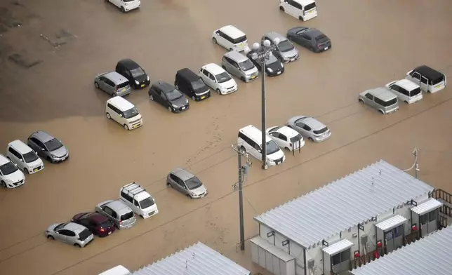 This aerial photo shows cars are submerged after heavy rain in Wajima, Ishikawa prefecture, Saturday, Sept. 21, 2024. (Kyodo News via AP)