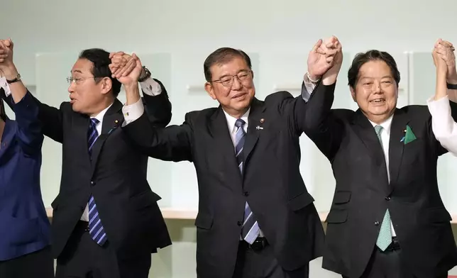 Shigeru Ishiba, center, celebrates after he was elected as new head of Japan's ruling Liberal Democratic Party (LDP) during the party's leadership election Friday, Sept. 27, 2024, in Tokyo. (AP Photo/Hiro Komae, Pool)