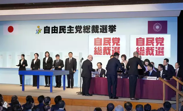 Officials show the result of the first voting to Election Commission during the Liberal Democratic Party's (LDP) leadership election at the party headquarters Friday, Sept. 27, 2024, in Tokyo. (AP Photo/Hiro Komae, Pool)