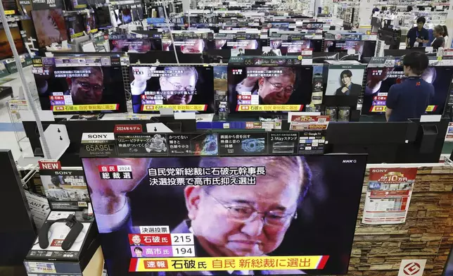 TV sets show a news proram reporting that Shigeru Ishiba is elected as leader of the Liberal Democratic Party, at an electronic shop in Urayasu, near Tokyo Friday, Sept. 27, 2024. (Kyodo News via AP)