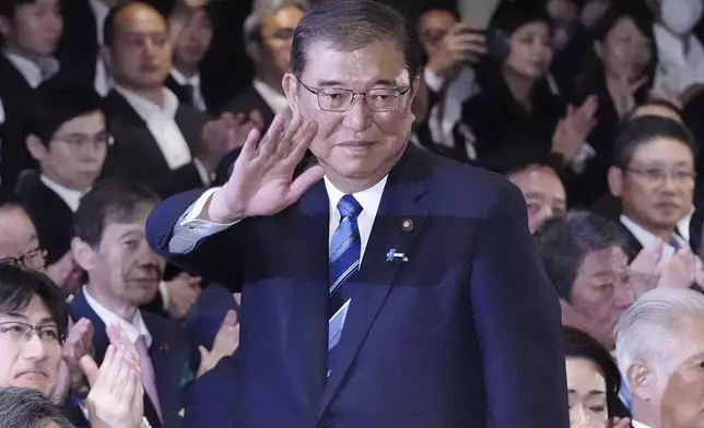 Shigeru Ishiba, center, waves as he is elected as leader of the ruling Liberal Democratic Party after the party's leadership election, in Tokyo Friday, Sept. 27, 2024. (Kyodo News via AP)