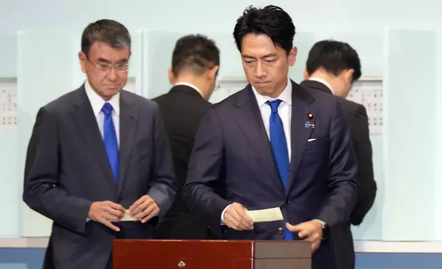 One of candidates, Shinjiro Koizumi, right, casts his ballot at the ruling Liberal Democratic Party's (LDP) leadership election at the party headquarters, Friday, Sept. 27, 2024, in Tokyo. (AP Photo/Hiro Komae, Pool)