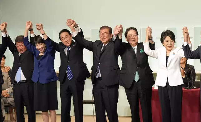 Shigeru Ishiba, center, celebrates after he was elected as new head of Japan's ruling party at the Liberal Democratic Party's leadership election Friday, Sept. 27, 2024, in Tokyo. (AP Photo/Hiro Komae, Pool)