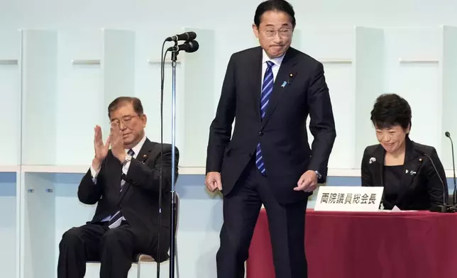 Japan's Prime Minister Fumio Kishida delivers a speech after Shigeru Ishiba, left, was elected as new head of Japan's ruling Liberal Democratic Party (LDP) during the party's leadership election Friday, Sept. 27, 2024, in Tokyo. (AP Photo/Hiro Komae, Pool)