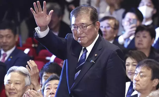 Shigeru Ishiba, center, waves as he is elected as leader of the ruling Liberal Democratic Party after the party's leadership election, in Tokyo Friday, Sept. 27, 2024. (Kyodo News via AP)