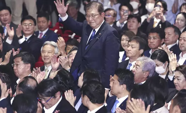 Shigeru Ishiba, center, waves as he is elected as leader of the ruling Liberal Democratic Party after the party's leadership election, in Tokyo Friday, Sept. 27, 2024. (Kyodo News via AP)